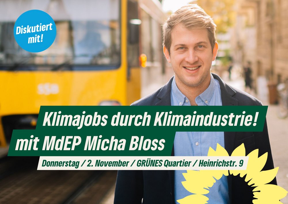 Foto von Micha Bloss, blonder Mann im Anzug, im Hintergrund eine Straße mit Straßenbahn. Text: Klimajobs durch Klimaindustrie! mit MdEP Micha Bloss